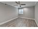 Bright bedroom features wood-look floors, ceiling fan, window and neutral gray walls at 346 Carpenter Dr # 29, Atlanta, GA 30328