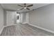 Bright bedroom features wood-look floors, ceiling fan, and hallway to another room at 346 Carpenter Dr # 29, Atlanta, GA 30328