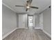 Bright bedroom features wood-look floors, ceiling fan, and hallway to another room at 346 Carpenter Dr # 29, Atlanta, GA 30328