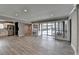 Open living room features wood-look floors and access to outdoor pool at 346 Carpenter Dr # 29, Atlanta, GA 30328