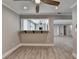 Open living space with wood flooring, white trim, bar to kitchen, and ceiling fan at 346 Carpenter Dr # 29, Atlanta, GA 30328