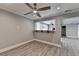 Living room featuring wood flooring, white trim, ceiling fan, and bar to additional living space at 346 Carpenter Dr # 29, Atlanta, GA 30328