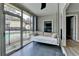 Cozy sunroom with a daybed swing, providing a relaxing view of the community pool and outdoor space at 346 Carpenter Dr # 29, Atlanta, GA 30328