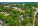 An aerial view of a neighborhood with tree-lined streets and various rooftops at 355 Highlands Trce, Roswell, GA 30075