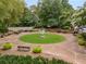 Scenic aerial view of the property with a flower monument in the center, surrounded by lush greenery and benches at 355 Highlands Trce, Roswell, GA 30075