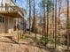 Backyard view showing the home's deck, landscaping, and mature trees at 355 Highlands Trce, Roswell, GA 30075
