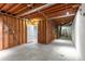 Unfinished basement with exposed ceiling, utility access, and concrete flooring at 355 Highlands Trce, Roswell, GA 30075
