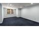 Finished basement with carpet, a window and ample space for recreation or storage at 355 Highlands Trce, Roswell, GA 30075