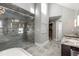 Modern bathroom featuring a walk-in shower with glass door, tile, and double vanity at 355 Highlands Trce, Roswell, GA 30075