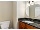 Bathroom featuring granite counters, custom wood cabinets, and a modern vanity at 355 Highlands Trce, Roswell, GA 30075