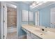 Well-lit bathroom featuring a vanity with cabinets and a shower-tub combo at 355 Highlands Trce, Roswell, GA 30075