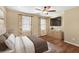 Comfortable bedroom with a ceiling fan, large TV, and ample natural light at 355 Highlands Trce, Roswell, GA 30075
