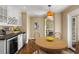 A breakfast nook features custom cabinets, modern appliances, and a breakfast table at 355 Highlands Trce, Roswell, GA 30075