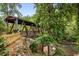 Scenic covered bridge view with a wooden structure surrounded by lush greenery and a flowing creek at 355 Highlands Trce, Roswell, GA 30075