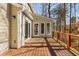 The back deck features wood floors and railing and overlooks a wooded backyard at 355 Highlands Trce, Roswell, GA 30075