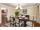 Formal dining room with classic chandelier, neutral walls and trim, and a view to the kitchen at 355 Highlands Trce, Roswell, GA 30075
