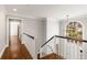 Bright hallway with dark hardwood floors and a large window at 355 Highlands Trce, Roswell, GA 30075