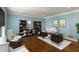 Bright home office with wood floors, built-in shelving, and modern furnishings at 355 Highlands Trce, Roswell, GA 30075