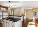 Open concept kitchen with island, black countertops, stainless steel refrigerator and lots of storage at 355 Highlands Trce, Roswell, GA 30075