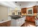 Gourmet kitchen with stainless steel appliances, granite countertops, and hardwood floors at 355 Highlands Trce, Roswell, GA 30075