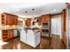 Kitchen featuring custom cabinets, stainless steel appliances, granite countertops, and a kitchen island at 355 Highlands Trce, Roswell, GA 30075