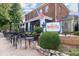 BayouQ's outdoor dining with an inviting bistro atmosphere, surrounded by lush greenery and a quaint building facade at 355 Highlands Trce, Roswell, GA 30075