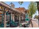 Vibrant outdoor dining with cafe-style seating under a rustic wooden awning, creating an inviting atmosphere at 355 Highlands Trce, Roswell, GA 30075
