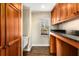 A pantry features custom wood cabinets, granite counters, and a utility sink at 355 Highlands Trce, Roswell, GA 30075