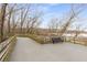 View from Riverwalk along the Reedy River with trees, a bench, and a wooden fence at 355 Highlands Trce, Roswell, GA 30075