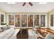 A sun room features floor to ceiling windows, hardwood floors, and great light at 355 Highlands Trce, Roswell, GA 30075