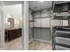 Organized walk-in closet with custom shelving and storage solutions, conveniently located next to the bathroom at 355 Highlands Trce, Roswell, GA 30075