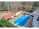 An aerial view shows this large backyard featuring a large in-ground pool at 384 Minix Rd, Sharpsburg, GA 30277