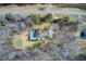 An aerial view of a property with a rectangular pool, trees, and a road nearby at 384 Minix Rd, Sharpsburg, GA 30277