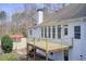 Rear exterior and wooden deck with view of rear yard and wooded surroundings at 384 Minix Rd, Sharpsburg, GA 30277