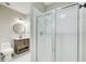 Bathroom featuring a sleek vanity, round mirror, and a shower with frosted glass doors at 384 Minix Rd, Sharpsburg, GA 30277