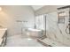 Modern bathroom with stand-alone tub and glass enclosed shower with marble surround at 384 Minix Rd, Sharpsburg, GA 30277