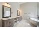 Bright bathroom features a double sink vanity, soaking tub, and modern fixtures at 384 Minix Rd, Sharpsburg, GA 30277