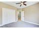 Bedroom with a ceiling fan, a closet, and a view into another room at 384 Minix Rd, Sharpsburg, GA 30277