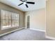 Comfortable bedroom featuring a ceiling fan, a large window, and a walk-in closet at 384 Minix Rd, Sharpsburg, GA 30277