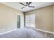 Cozy bedroom featuring a ceiling fan, a large window, and a walk-in closet at 384 Minix Rd, Sharpsburg, GA 30277