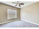 A bright, cozy bedroom with a fan, a window, and neutral tones at 384 Minix Rd, Sharpsburg, GA 30277