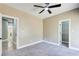 Bedroom with neutral tones, grey carpet, two doors, and baseboard trim at 384 Minix Rd, Sharpsburg, GA 30277