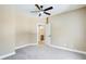 This carpeted bedroom features a ceiling fan and an open door to the bathroom at 384 Minix Rd, Sharpsburg, GA 30277