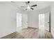 Bedroom boasts wood-look flooring, a ceiling fan, and two entryways for easy access at 384 Minix Rd, Sharpsburg, GA 30277