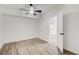 Bedroom features a ceiling fan, wood-look floors, and an open doorway to the next room at 384 Minix Rd, Sharpsburg, GA 30277