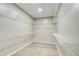 Walk-in closet with built-in shelving and hardwood floors at 384 Minix Rd, Sharpsburg, GA 30277