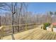 New wooden deck with wooded view and cable railing at 384 Minix Rd, Sharpsburg, GA 30277
