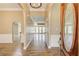Inviting foyer features hardwood floors and arched doorways, leading to a bright living area with multiple windows at 384 Minix Rd, Sharpsburg, GA 30277