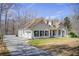 View of the home's exterior with a long driveway and a well-maintained lawn at 384 Minix Rd, Sharpsburg, GA 30277