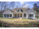 Charming home featuring a well-manicured lawn, brick facade, and inviting entrance at 384 Minix Rd, Sharpsburg, GA 30277